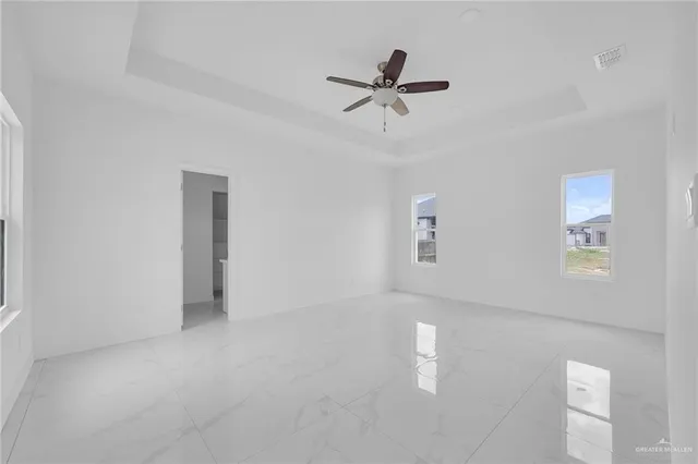 a view of a livingroom with a ceiling fan and window