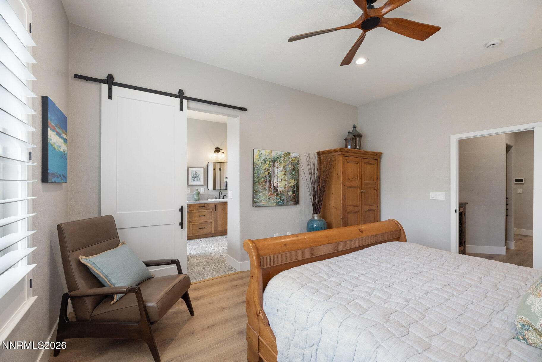 1290 El Monte Court Reno, NV 89521 - Photo 16 of 37 a bedroom with a bed and a chair