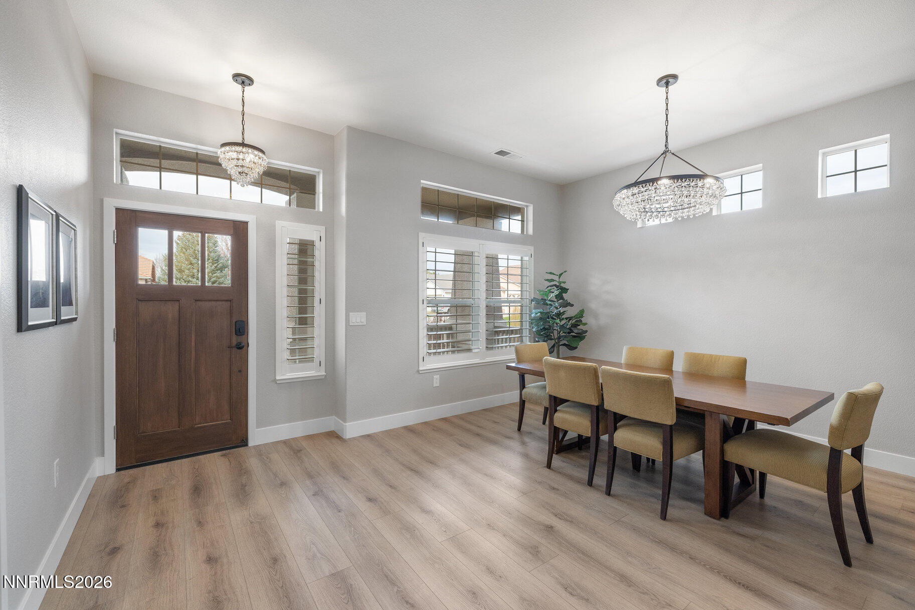 1290 El Monte Court Reno, NV 89521 - Photo 2 of 37 a dining room with wooden floor a chandelier a wooden table and chairs