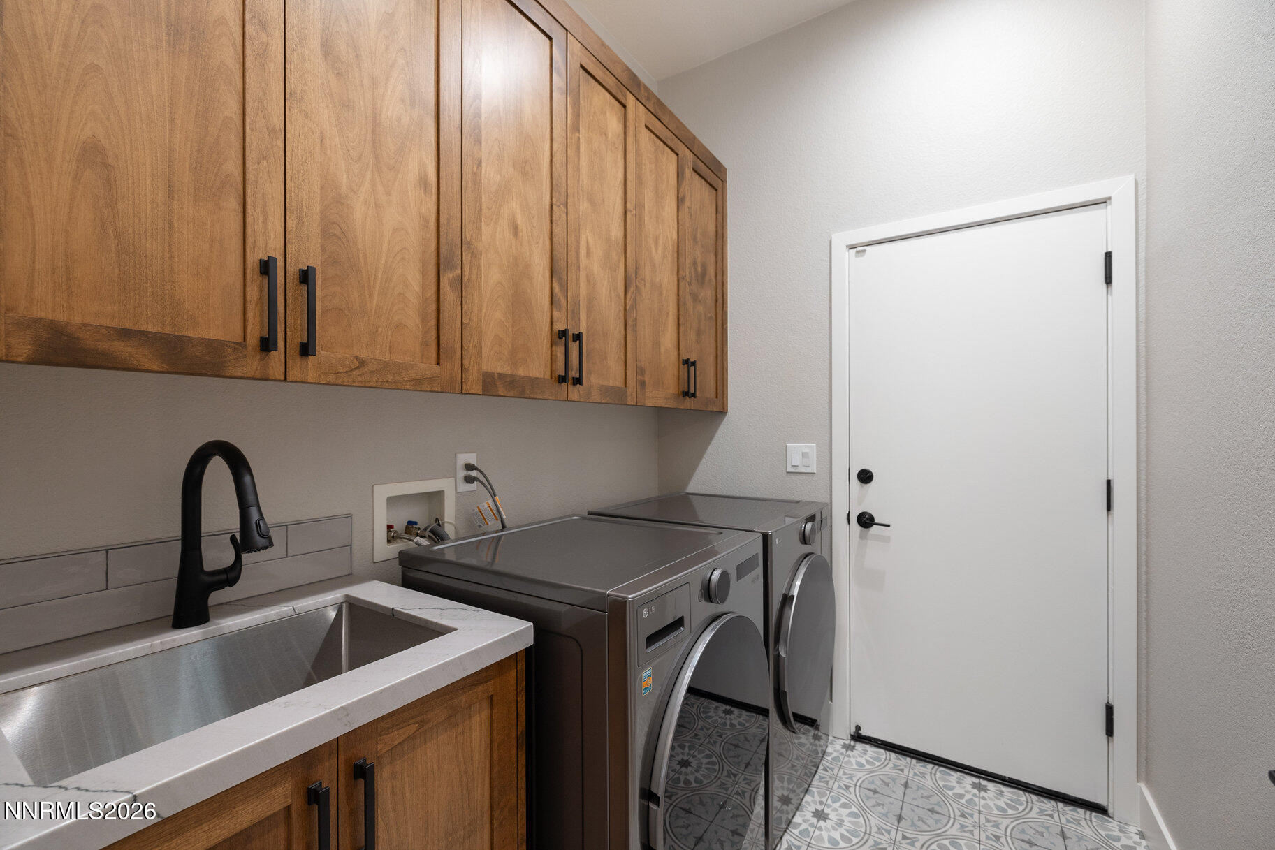 1290 El Monte Court Reno, NV 89521 - Photo 25 of 37 a kitchen with a sink a stove and cabinets