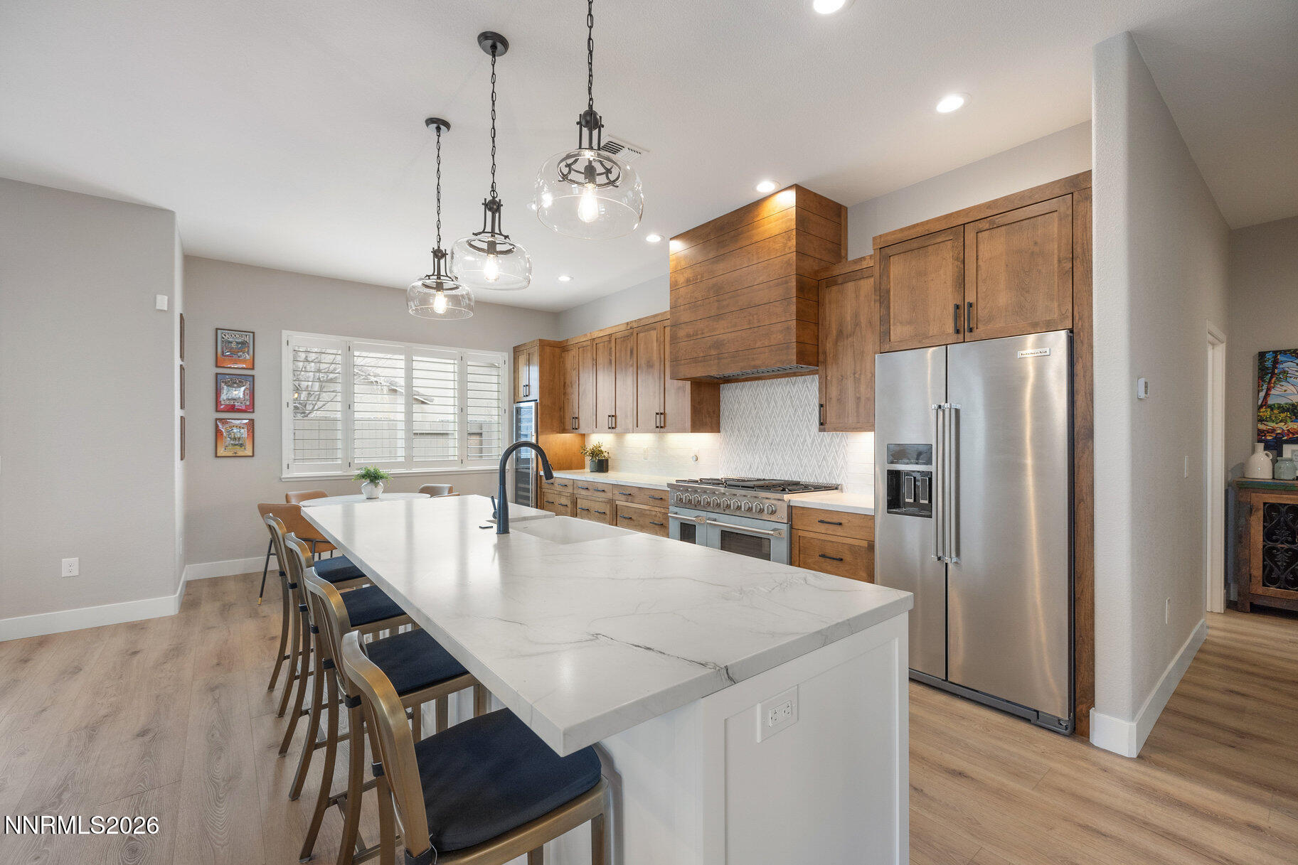 1290 El Monte Court Reno, NV 89521 - Photo 5 of 37 a kitchen with refrigerator cabinets dining table and wooden floor