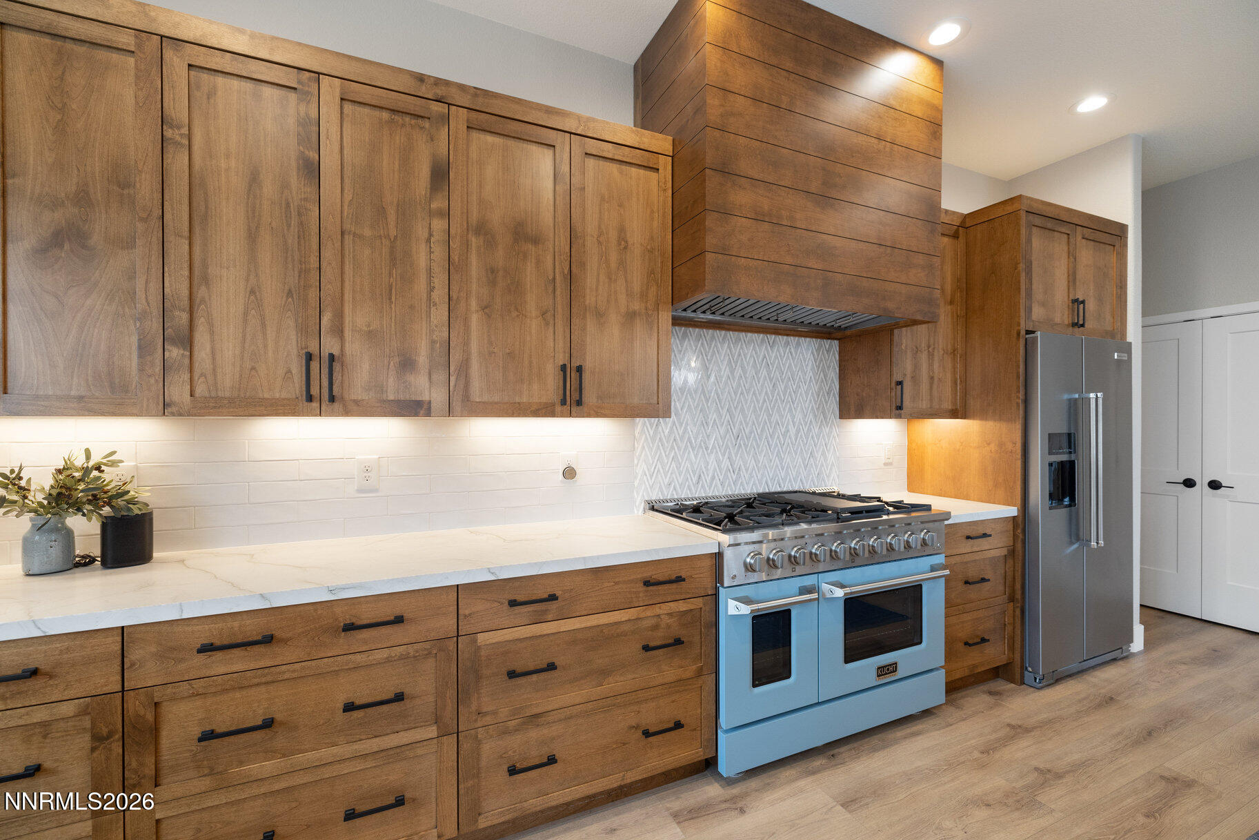 1290 El Monte Court Reno, NV 89521 - Photo 6 of 37 a kitchen with granite countertop a stove cabinets and stainless steel appliances