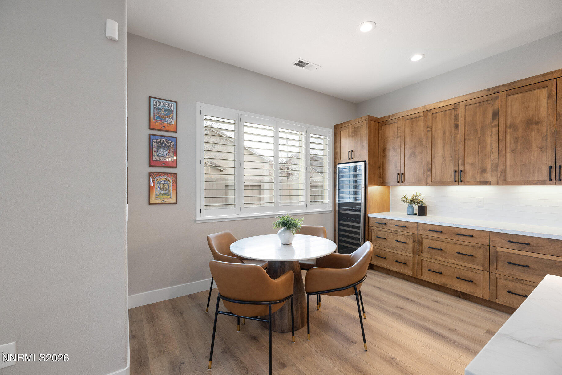 1290 El Monte Court Reno, NV 89521 - Photo 7 of 37 a kitchen with a dining table chairs and white cabinets