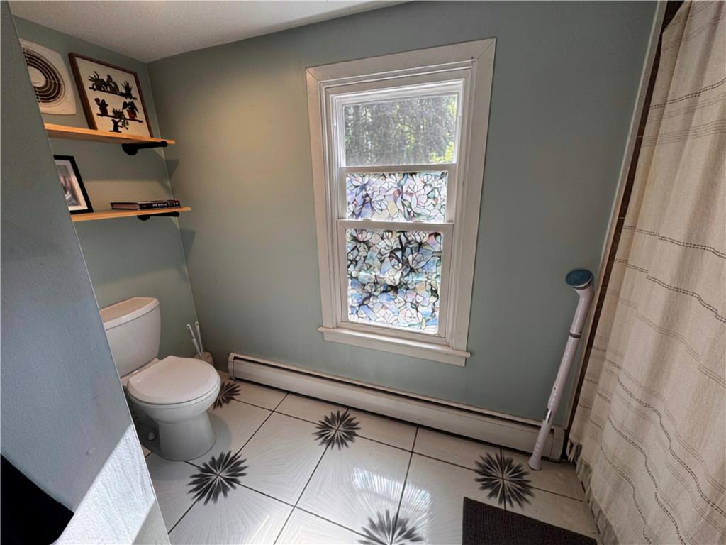 108 Effort Neola Road Effort, PA 18330 - Photo 24 of 31 A quaint bathroom with a decorative window and patterned tile flooring.