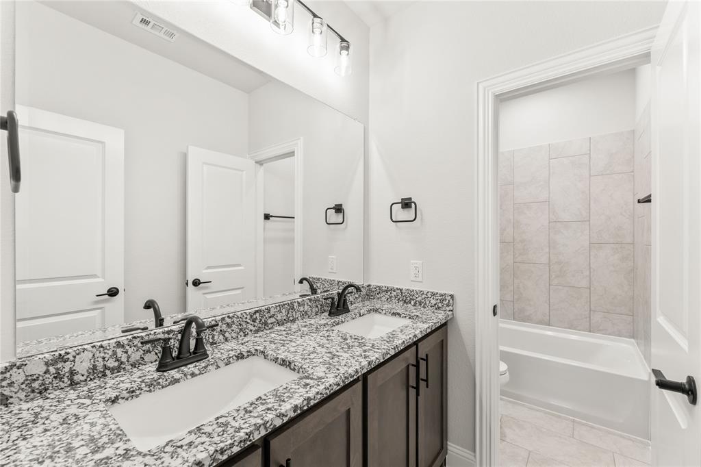 4213 Bel Air Drive Midlothian, TX 76065 - Photo 30 of 40 a bathroom with a granite countertop sink and a mirror