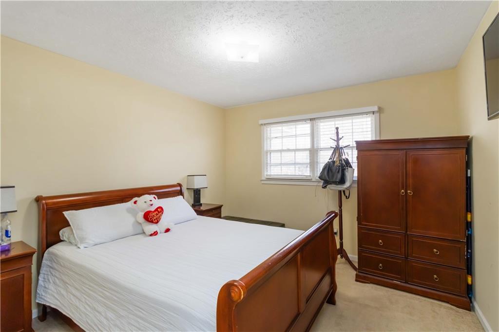 3829 Reynolds Road Douglasville, GA 30135 - Photo 11 of 24 a bedroom with a bed and a dresser