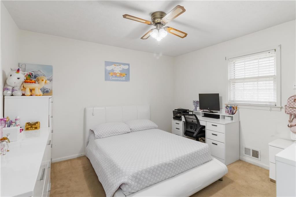 3829 Reynolds Road Douglasville, GA 30135 - Photo 12 of 24 a bedroom with a bed and a flat screen tv