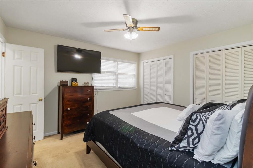 3829 Reynolds Road Douglasville, GA 30135 - Photo 13 of 24 a bedroom with a bed and a flat screen tv