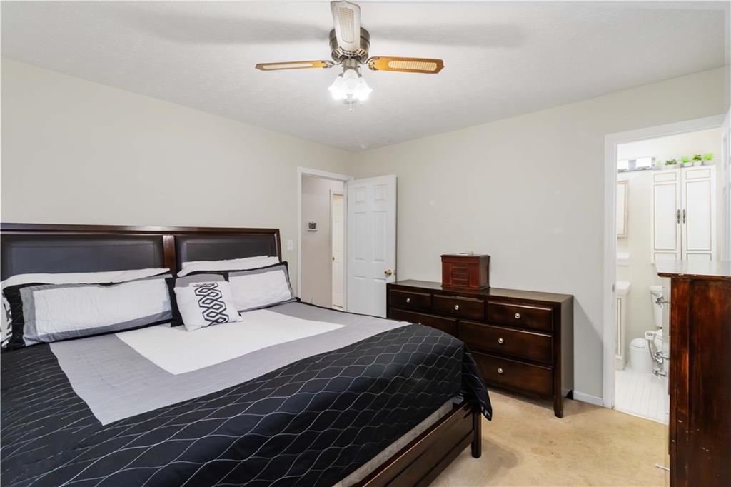 3829 Reynolds Road Douglasville, GA 30135 - Photo 14 of 24 a bedroom with a bed and a chandelier