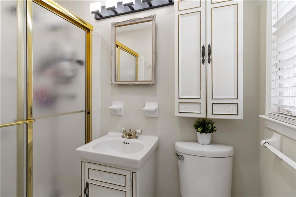 3829 Reynolds Road Douglasville, GA 30135 - Photo 15 of 24 a bathroom with a sink a mirror and a toilet