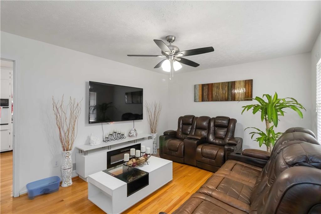 3829 Reynolds Road Douglasville, GA 30135 - Photo 6 of 24 a living room with furniture a flat screen tv and a fireplace