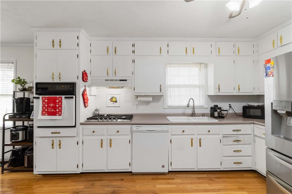 3829 Reynolds Road Douglasville, GA 30135 - Photo 9 of 24 a kitchen with granite countertop a white cabinets and sink