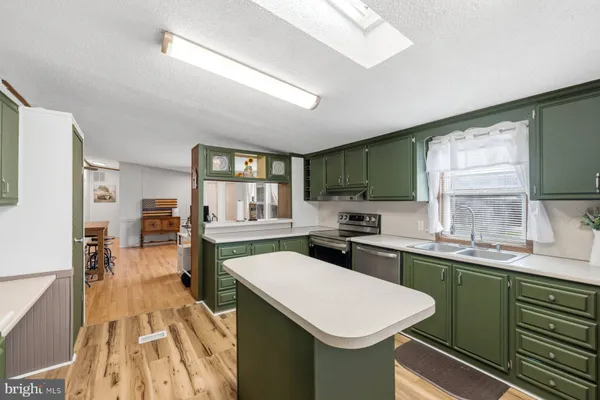 a kitchen with a sink stove and cabinets