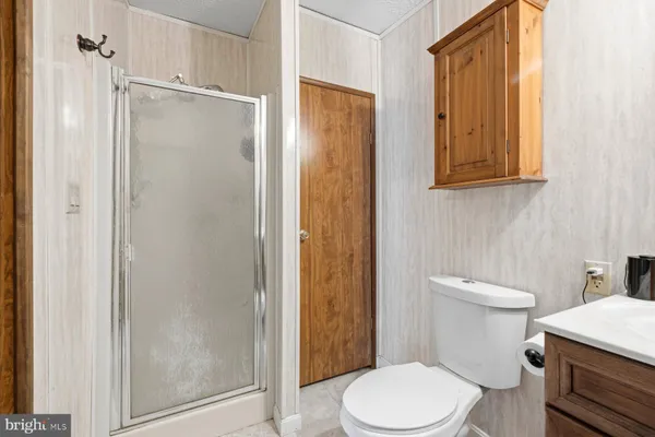a white toilet sitting next to a bathroom sink