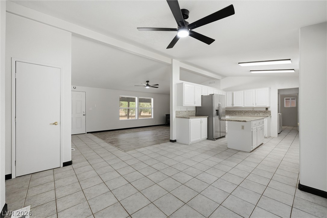 1531 West Harris Farm Road Pahrump, NV 89060 - Photo 37 of 37 A well-lit open floor plan seamlessly connects the kitchen and living areas, offering modern living.
