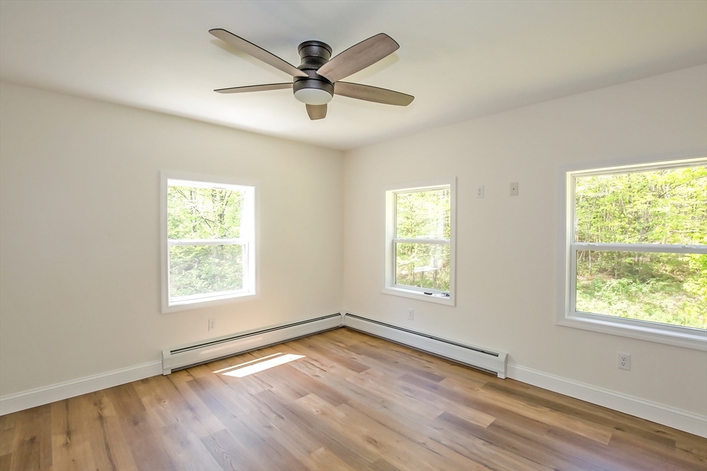 165 Sandisfield Road Sandisfield, MA 01255 - Photo 29 of 37 a view of an empty room with wooden floor and a window