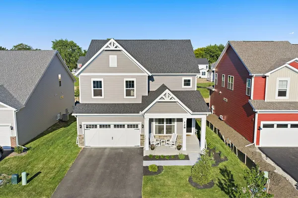 a aerial view of a house next to a yard