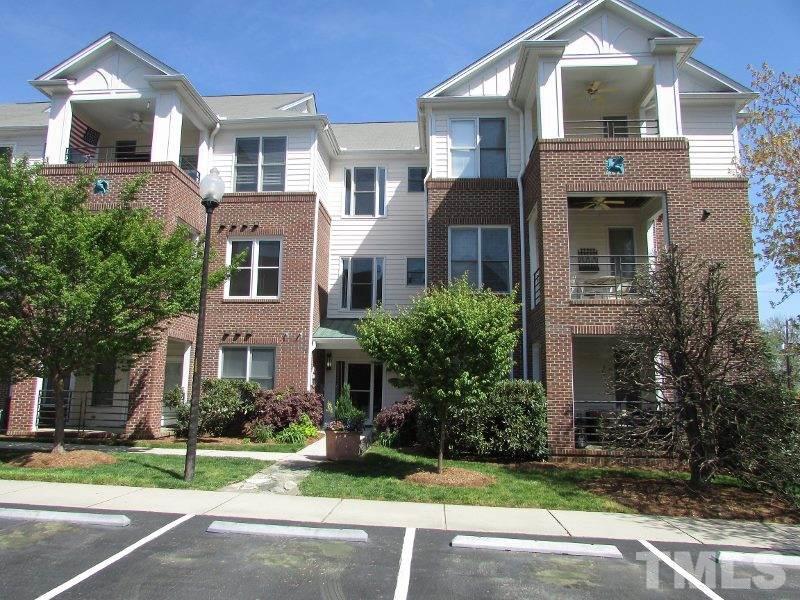 720 North Person Street, Unit 103 Raleigh, NC 27604 - Photo 1 of 13 a front view of a house with a yard