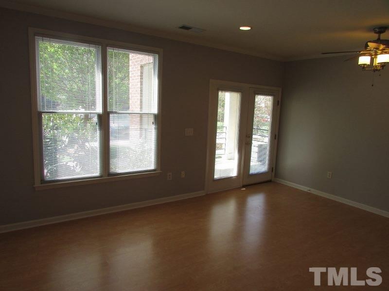 720 North Person Street, Unit 103 Raleigh, NC 27604 - Photo 2 of 13 a view of an empty room with a window and wooden floor