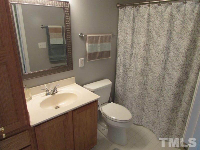 720 North Person Street, Unit 103 Raleigh, NC 27604 - Photo 11 of 13 a bathroom with a sink a toilet and shower