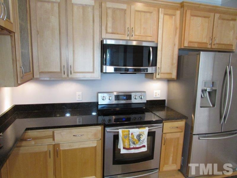 720 North Person Street, Unit 103 Raleigh, NC 27604 - Photo 5 of 13 a kitchen with a stove and a microwave