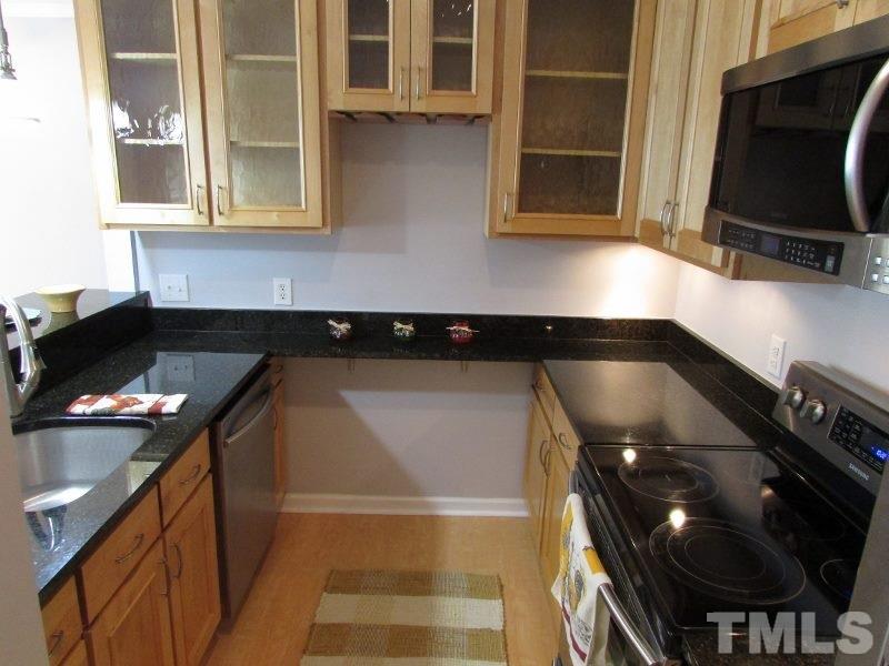 720 North Person Street, Unit 103 Raleigh, NC 27604 - Photo 6 of 13 a kitchen with a sink and cabinets