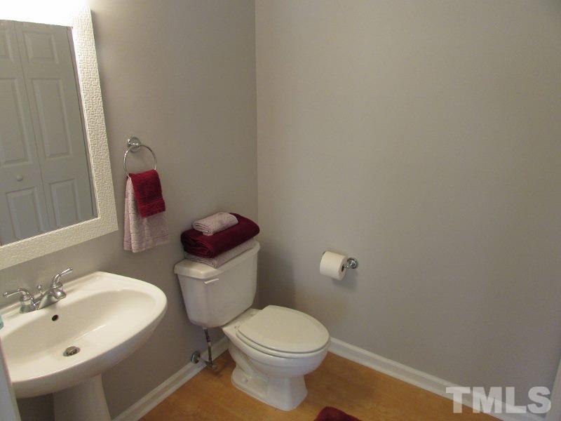 720 North Person Street, Unit 103 Raleigh, NC 27604 - Photo 9 of 13 a white toilet sitting next to a bathroom sink