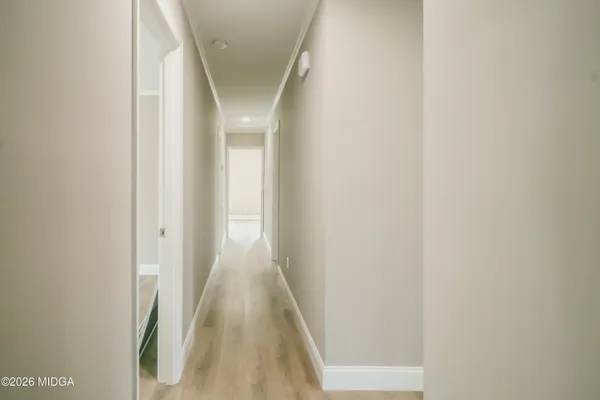a view of a hallway with wooden floor