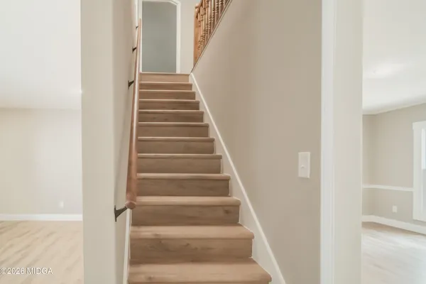 a view of staircase with white walls