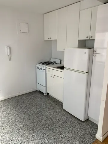 a utility room with cabinets washer and dryer