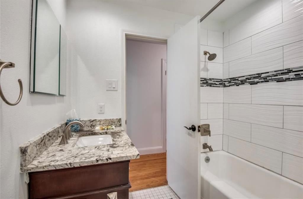 13038 Copenhill Road Dallas, TX 75240 - Photo 14 of 15 Bathroom featuring a single vanity with a granite countertop, undermount sink, and brushed nickel faucet