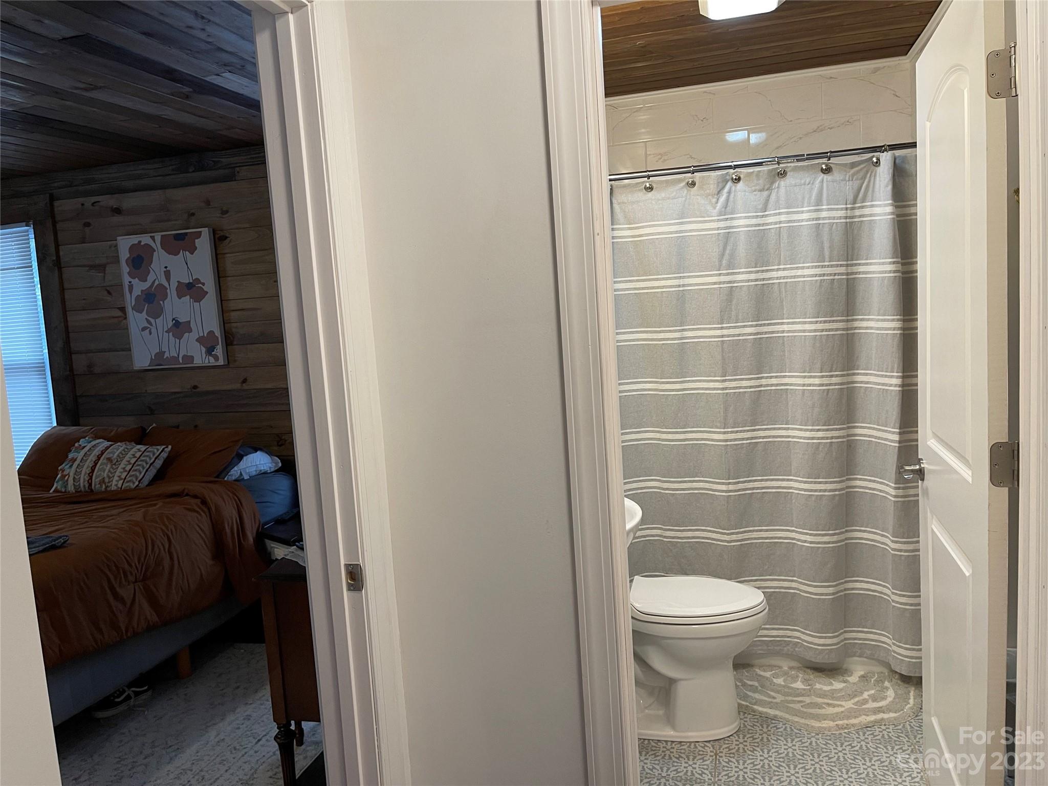 499 Union Cemetery Road Southwest Concord, NC 28027 - Photo 10 of 19 a bathroom with a toilet and a shower curtain