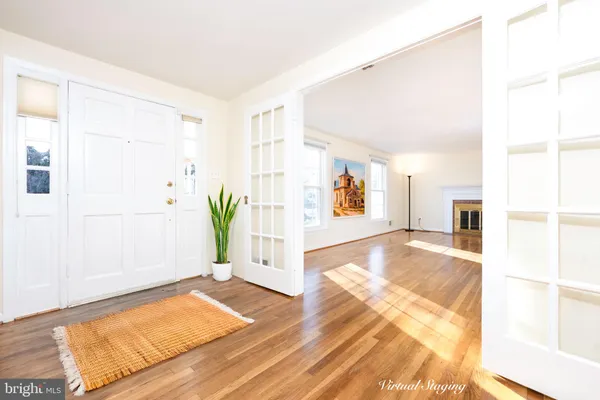 a view of a bedroom with wooden floor and a potted plant