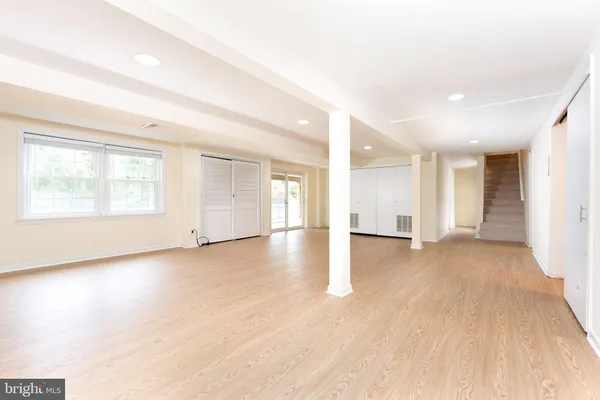 a view of a livingroom with wooden floor and a window