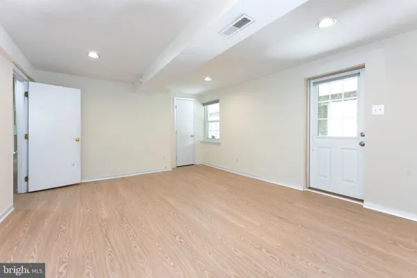 an empty room with windows and closet