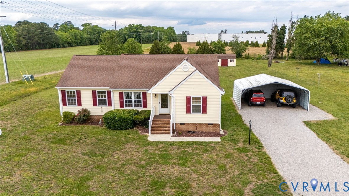 5280 West Quaker Road Disputanta, VA 23875 - Photo 11 of 33 a front view of a house with a yard