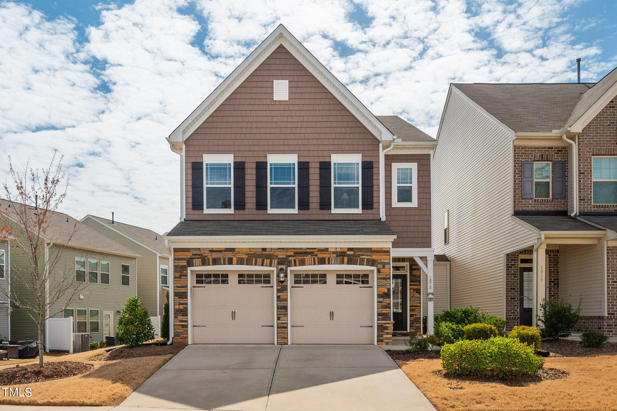 1016 Epiphany Road Morrisville, NC 27560 - Photo 1 of 45 a view of a white house with a large window and potted plants