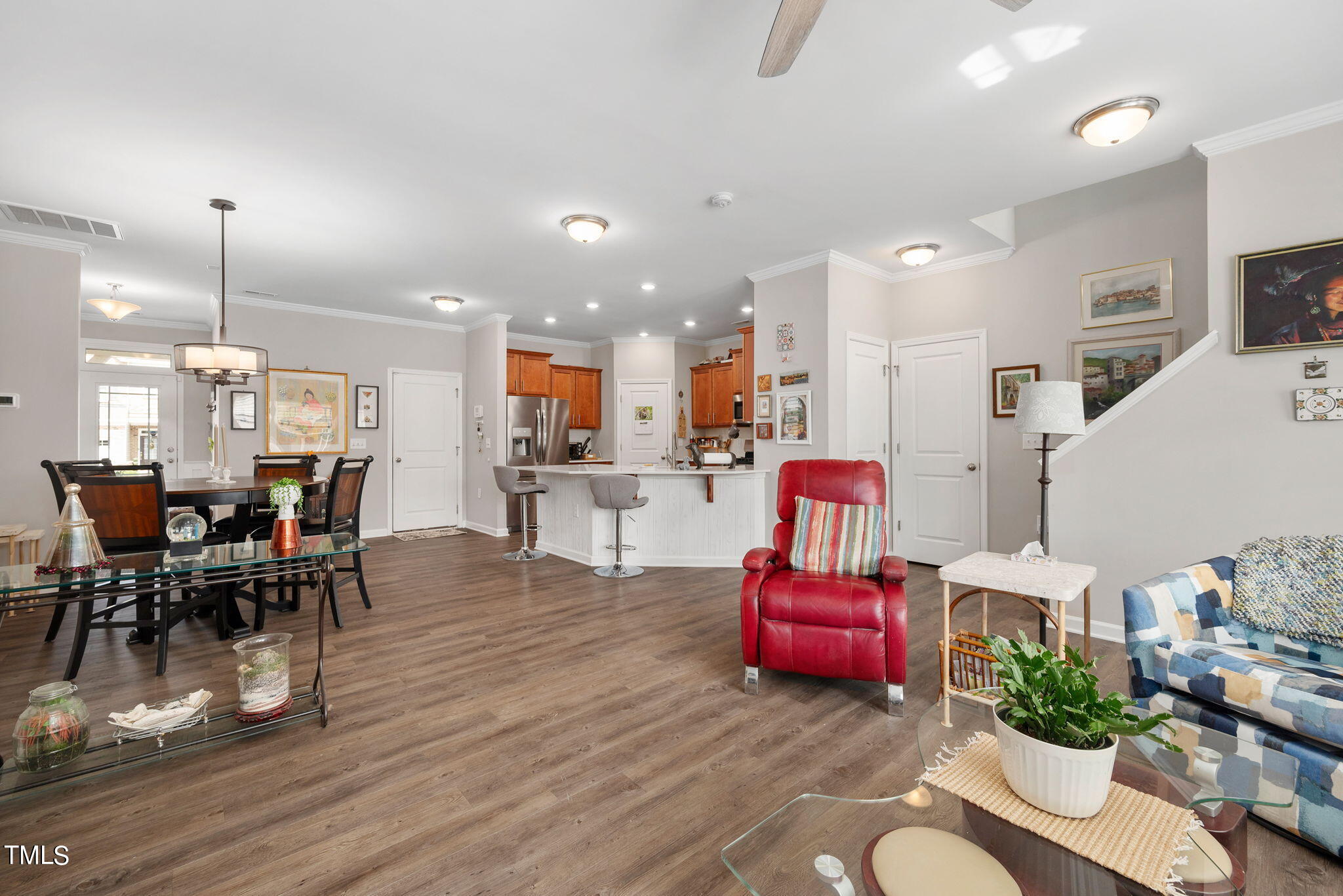 1016 Epiphany Road Morrisville, NC 27560 - Photo 15 of 45 a living room with furniture kitchen view and a wooden floor