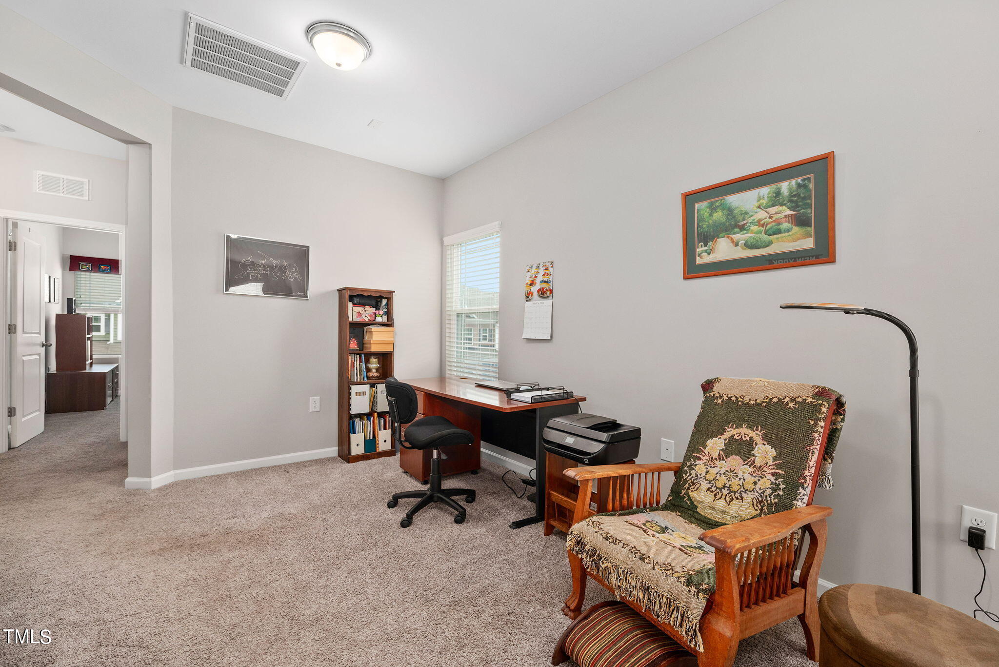 1016 Epiphany Road Morrisville, NC 27560 - Photo 18 of 45 a living room with furniture and a book shelf
