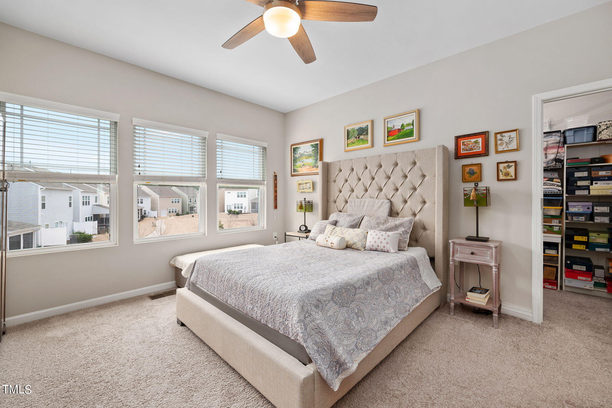 1016 Epiphany Road Morrisville, NC 27560 - Photo 19 of 45 a bedroom with a large bed and a chandelier