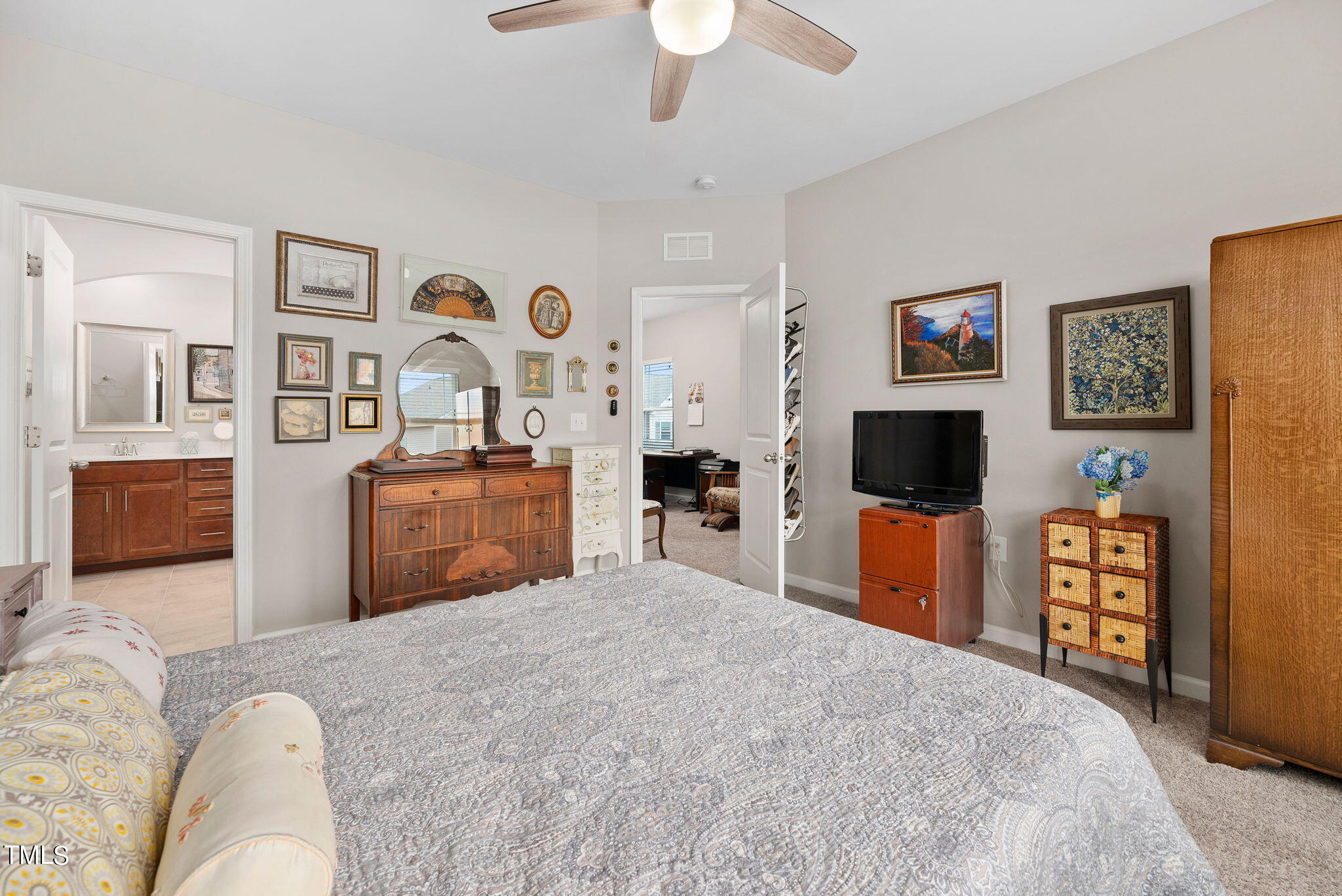 1016 Epiphany Road Morrisville, NC 27560 - Photo 20 of 45 a bedroom with a bed and a flat screen tv
