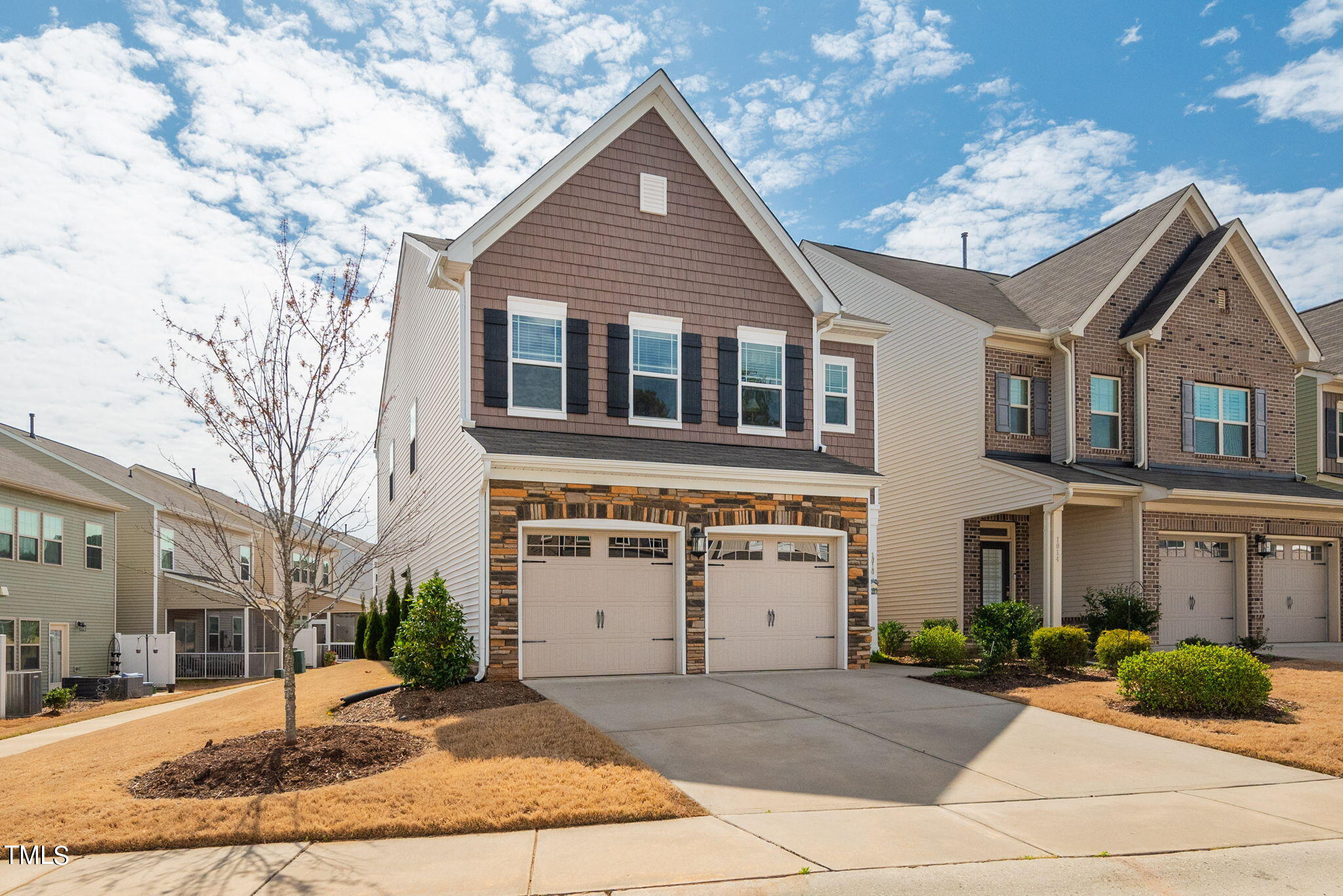 1016 Epiphany Road Morrisville, NC 27560 - Photo 2 of 45 a front view of a house with a yard and potted plants