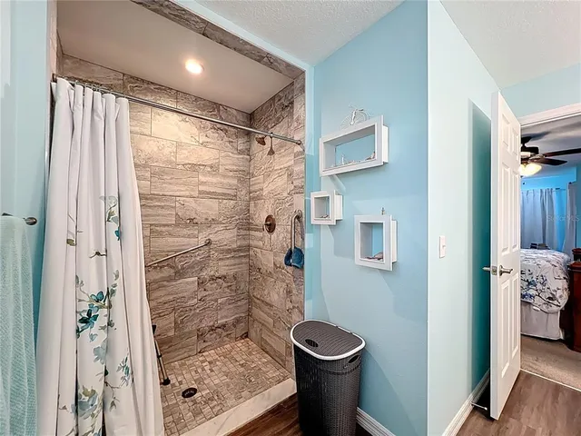 a bathroom with a toilet and a shower
