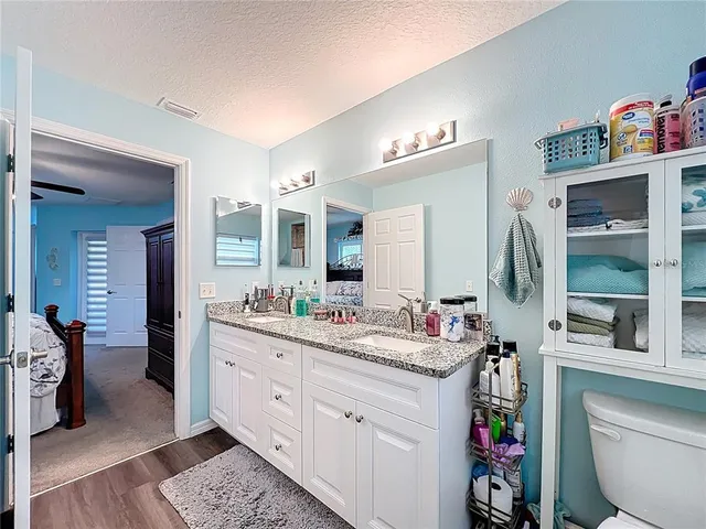 a spacious bathroom with a double vanity sink and a mirror