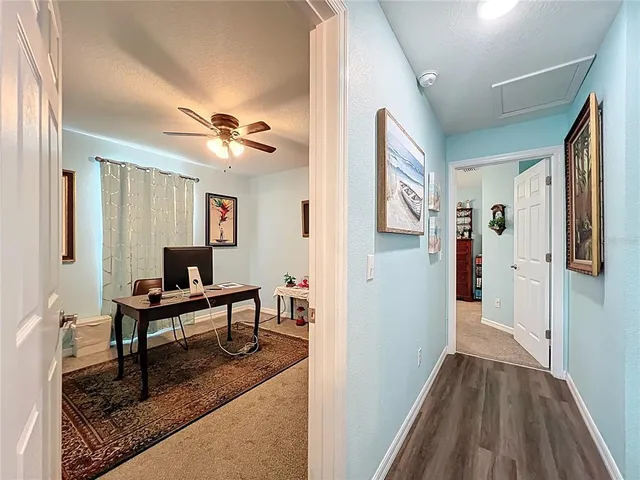 a view of a livingroom with furniture and a chandelier fan