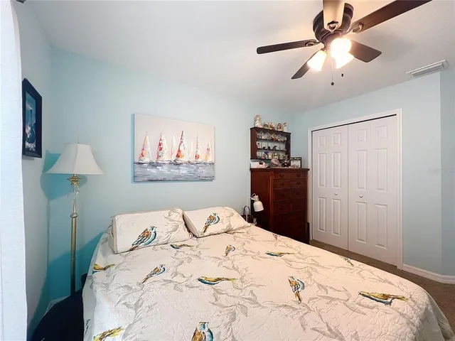 a bedroom with a bed and a painting on the wall