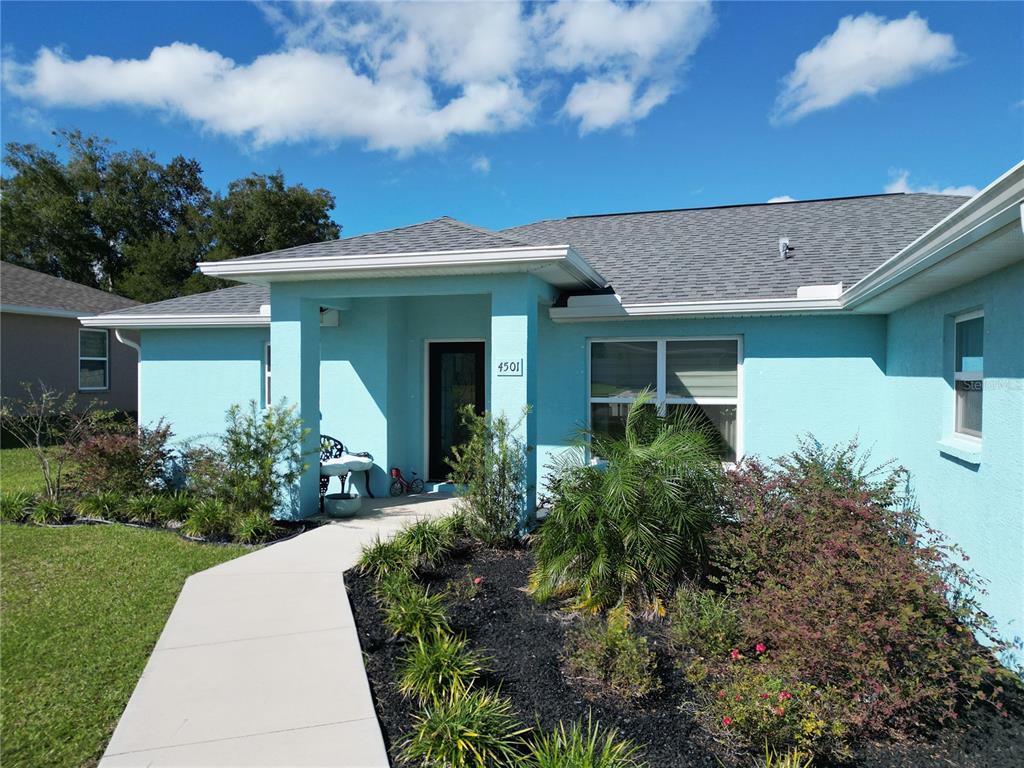 4501 East Ravenna Street Inverness, FL 34453 - Photo 2 of 31 a front view of a house with garden