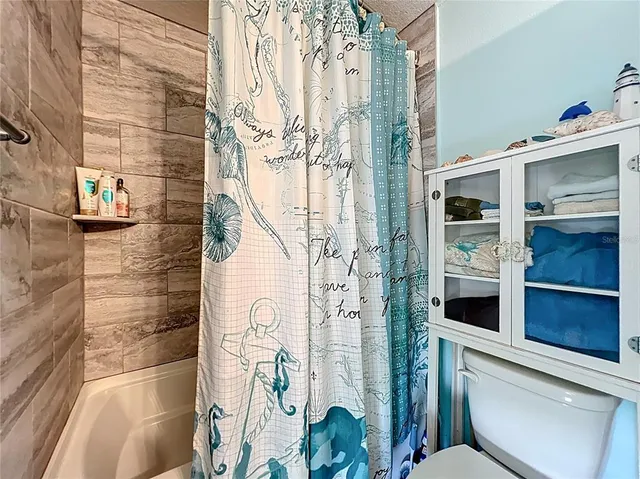 a bathroom with a toilet and shower