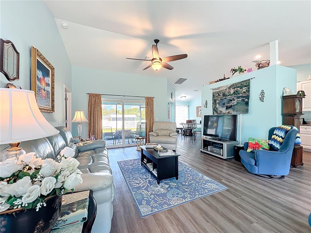 4501 East Ravenna Street Inverness, FL 34453 - Photo 3 of 31 a living room with furniture and a flat screen tv