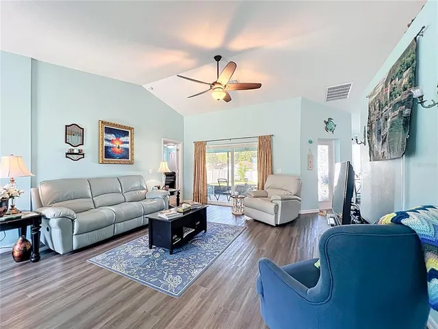 a living room with furniture or couch and a wooden floor
